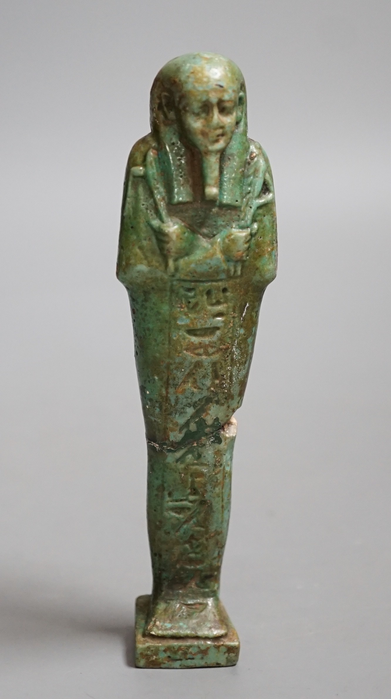 An Egyptian turquoise glazed faience ushabti, possibly Late Kingdom. 14.5cm